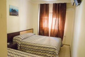 Postel nebo postele na pokoji v ubytování Hostal la Campana