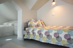 a bedroom with a bed with a colorful comforter at Camara Homes in Andros