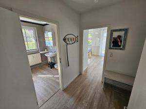 a person taking a picture of a hallway with a mirror at Strandnahe FeWo Sonneneck auf Poel mit Garten & Stellplatz in Insel Poel +5 photos