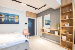 a bedroom with a bed and a desk at Studio President 80 in Craiova +6 photos