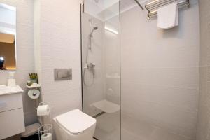 a bathroom with a toilet and a glass shower at Studio President 80 in Craiova