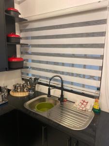 a kitchen counter with a sink and a sink at Peanut Cottage Bulawayo in Bulawayo +30 photos