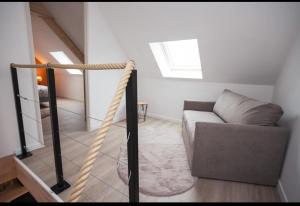 a living room with a couch and a window at L'avocette Gîtes de la réserve in Grand-Laviers