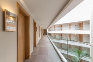 an empty hallway in a building with glass floors at Boyalik Beach Hotel & Spa Cesme in Çeşme