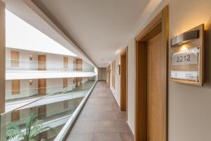 an empty corridor in a hospital with a glass walkway at Boyalik Beach Hotel & Spa Cesme in Çeşme