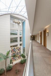 a hallway of a building with a glass ceiling at Boyalik Beach Hotel & Spa Cesme in Çeşme