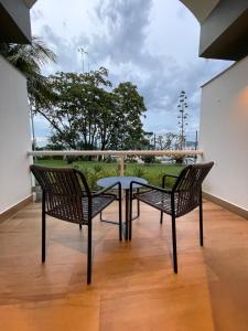 two chairs and a table on a balcony at Hotel Senac Ilha do Boi in Vitória