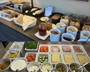 a counter with different types of food in containers at Hotel Milton in Jyväskylä