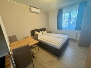 A bed or beds in a room at Silver Boglár Apartman