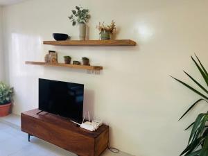 a living room with a flat screen tv on a wall at Aksil Jaam in Dakar +8 photos
