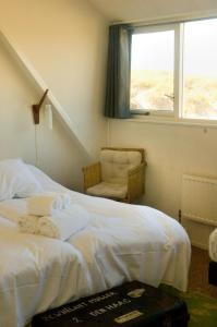 Postel nebo postele na pokoji v ubytování Strandhotel Terschelling B&B