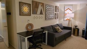 a living room with a couch and a desk at Lovely 1 Bedroom Condo in the Heart of Seattle! in Seattle