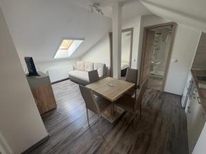 a living room with a table and a couch at Silver Boglár Apartman in Balatonboglár