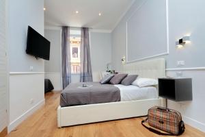 a bedroom with a bed and a flat screen tv at St. Peter Vatican Rooms in Rome