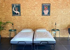 two beds in a room with posters on the wall at Loft Bike & Chill in Entrechaux +19 photos