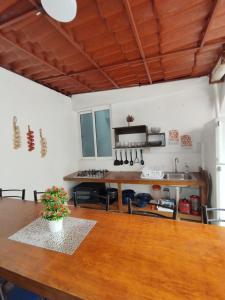 a kitchen with a wooden table and a counter top at Hospedaje Casa Azul in Mexico City