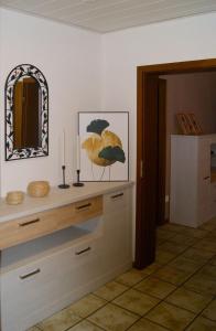 a room with a counter with two candles and a mirror at Monteurswohnung - Barlo - 4 Personen in Bocholt