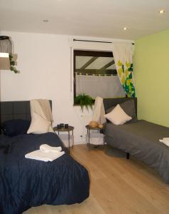 a living room with two beds and a couch at Monteurswohnung - Barlo - 4 Personen in Bocholt