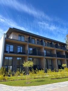 an apartment building with balconies on the side of it at Albatross 949 by the Sea in Ķesterciems
