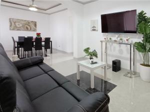 a living room with a couch and a table at Medellin Beachvilla 5BR | Billiard | Fiber 100Mbps in Medellin