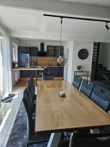 a dining room and kitchen with a wooden table and chairs at MaxMir - Ortlohn Iserlohn in Iserlohn