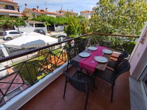 a balcony with a table and chairs on it at Villa Veta, Nikiti beach in Nikiti