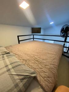 a large bed in a room with a ceiling at Pousada do sol in Sorocaba