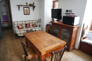 a living room with a wooden table and a couch at Casa nella valle in Groscavallo