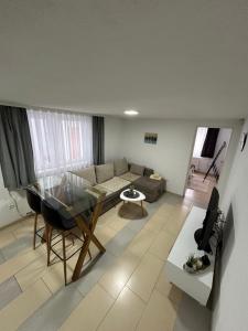 a living room with a couch and a table at Apartmani Star in Tuzla