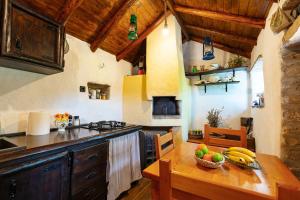 a kitchen with a table with a bowl of fruit on it at Meadow Hill in Žrnovo