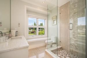 a bathroom with a shower and a toilet and a window at Vancouver Shangrila House in Richmond +45 photos