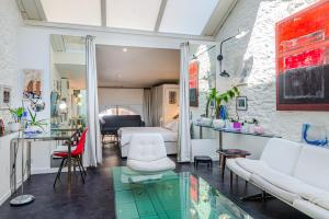 a living room with a bed and a glass table at MODERN LOFT near BEACH in Dinard