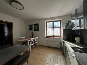 a kitchen with a table and a dining room at Apartmán 2 jeseň-zima in Martin