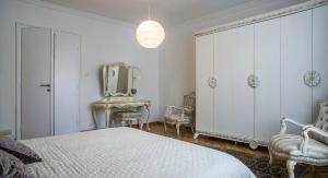 a bedroom with a bed and a mirror and a dresser at Apartment in city center of Belgrade in Belgrade