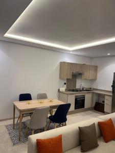 a living room with a table and a couch at Casablanca Finance City 33 Tower in Casablanca +6 photos