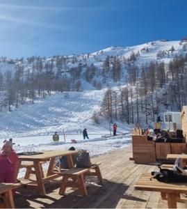 a group of people sitting at a table on a ski slope at Bed&Breakfast La Sctalèta in Mesocco