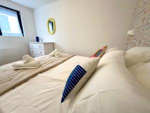 a bedroom with two beds with pillows on them at Appartement le Pop Art, à deux pas du Port in Le Tréport