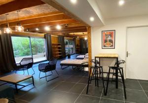 a living room with chairs and a table and a bed at Loft Bike & Chill in Entrechaux
