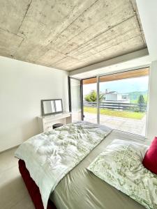 a bedroom with a large bed and a large window at Moderne Ferienwohnung in Bergisch Gladbach in Bergisch Gladbach