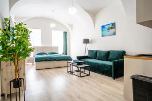 a living room with a couch and a table at Luxapart V Beautiful Views with Breakfast option in Košice