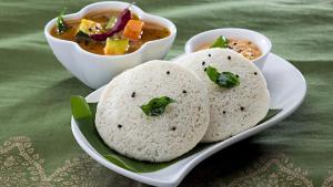 a plate of food with two tortillas and a bowl of soup at Hotel CORAL COVEE Near Delhi Airport BY GROSS GROUP in New Delhi +31 photos