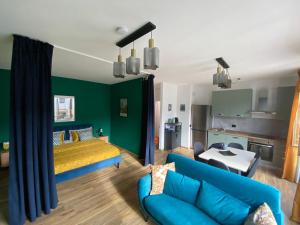 a bedroom with a blue couch and a green wall at Lakeside Lugano in Lugano