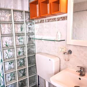 a bathroom with a toilet and a sink at Athena in Camporosso