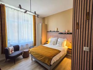Ένα ή περισσότερα κρεβάτια σε δωμάτιο στο Les Appartements de la Nef d'Or