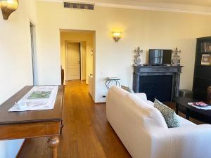 a living room with a couch and a fireplace at Serena Apartment in Lucca