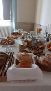 a table topped with lots of different types of food at Palazzo Mattei b&b and charming rooms in Novafeltria