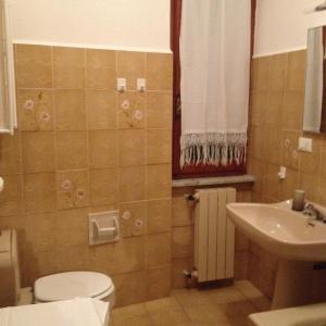 a bathroom with a toilet and a sink at Casa Del Mulino in Levanto
