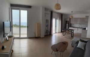 a living room with a couch and a table at Dora's apartment in Dhërmi