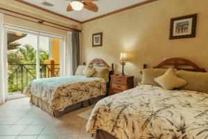 a bedroom with two beds and a balcony at CR Luxury Veranda 7B 2 Bdrm in La Mona +23 photos