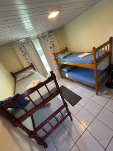 Кровать или кровати в номере Casa Verde - 5 quartos a 600m Praia e próximo Beto Carrero